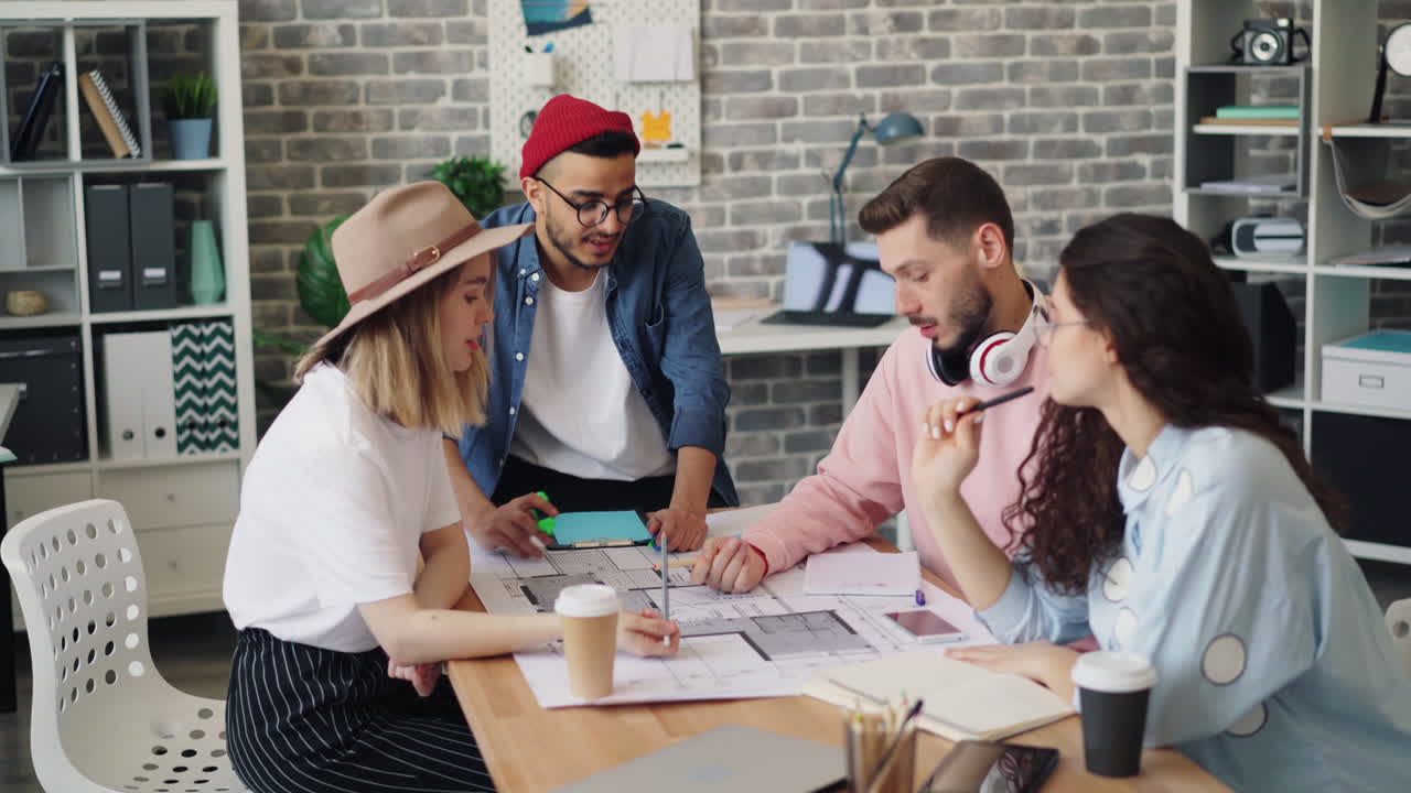 Team Discussing Architectural Plans in Modern Office