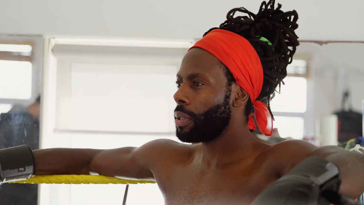 boxeador masculino relajándose en el ring de boxeo 4k