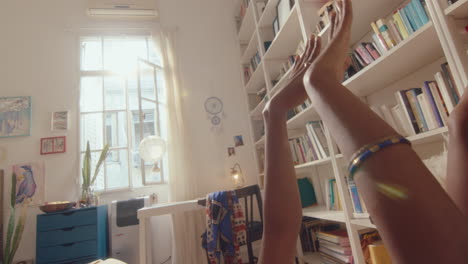 Girl Lying on Bed with Legs Up and Dancing at Home