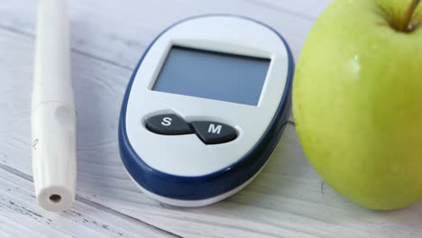 blood glucose meter and apple