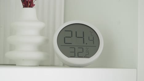 modern digital thermometer and humidity display on a shelf