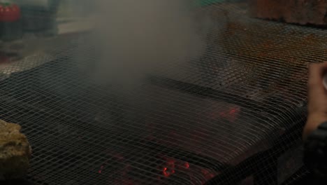 Closeup-View-of-hands-prepping-meal-at-BBQ-Grill-using-a-leek