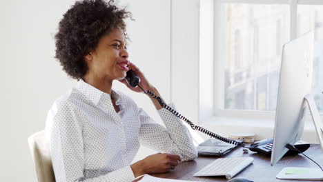 young black woman on the phone in an office, close up