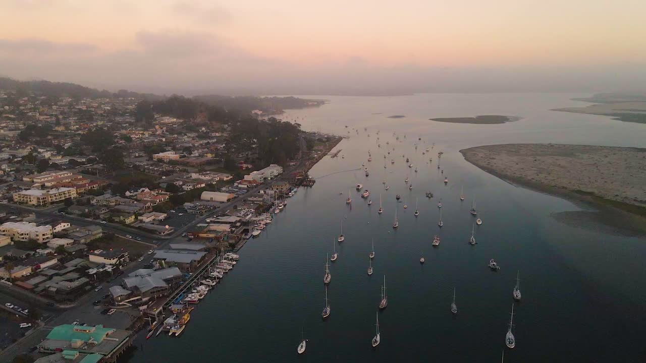 Aerial View of Coastal Town with Boats at Sunset