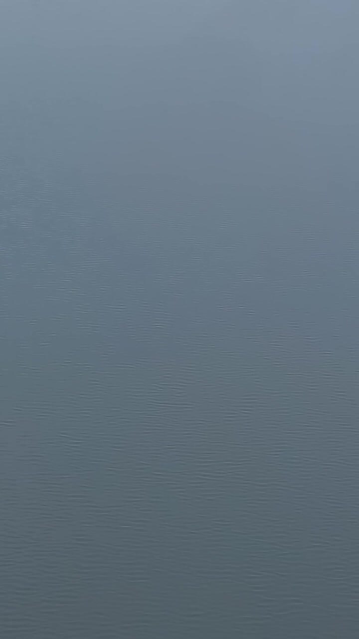View of the river in Malbork Poland showing calm waters and land