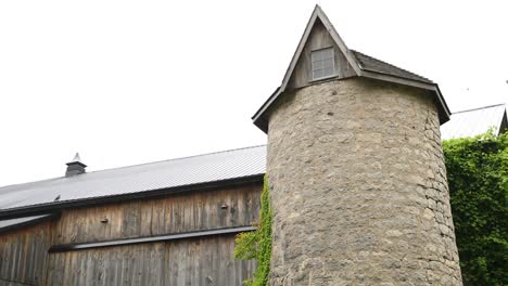 rural wood barn with old stone silo in 4k