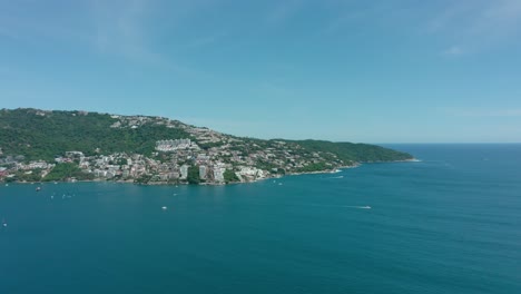 Aerial-drone-shot-above-blue-pacific-ocean-near-Mexico-city-at-day,-wide-angle