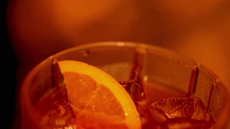 close-up of a negroni cocktail with orange slice