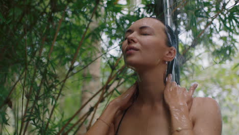 beautiful woman in shower wearing bikini washing body cleansing skin with refreshing water enjoying natural beauty spa showering outdoors in nature