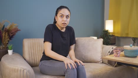 young woman looking at camera with coward expression.