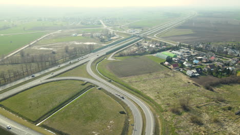 View-From-The-Drone-Road-Traffic-Outside-The-City-near-green-field