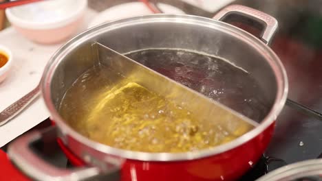 simmering hotpot soup in a divided pot