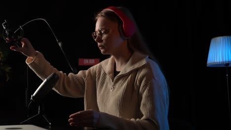 woman recording podcast in home studio