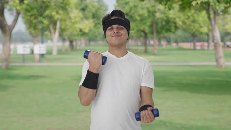 Happy-Indian-man-lifting-dumbbells