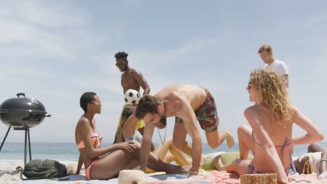 group of mixed-race friends relaxing on the beach 4k