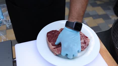 preparing raw ribeye steaks for grilling