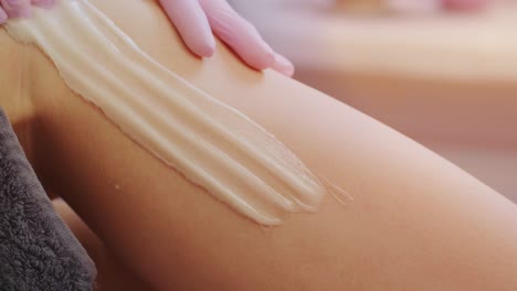 female legs depilation by honey or sugar pasta. sugaring hair removal. beauty concept. sugaring. epilation process. legs.