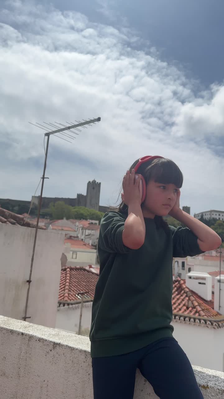 Girl listening to music on a rooftop