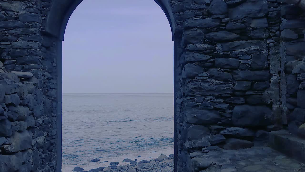 Arch of stone passage on rocky beach in Sao Jorge, Madeira
