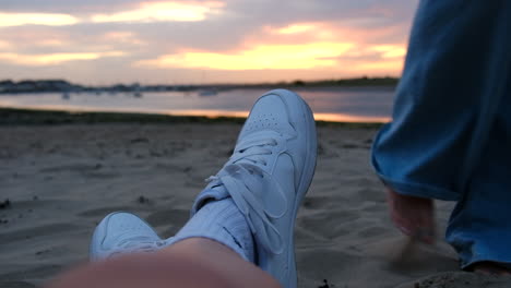 2 people enjoying sunset and walking in the sand