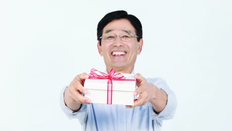 middle-aged asian man holding a present