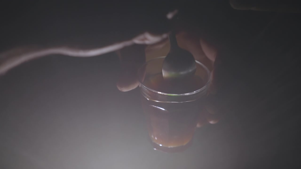 A man stirring a turkish coffee in a cup
