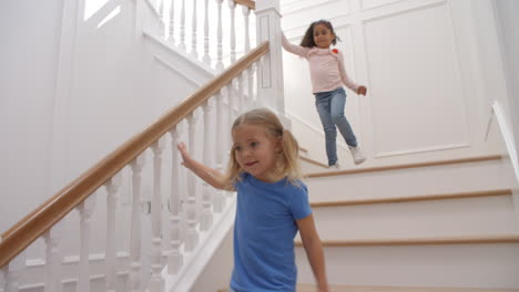 two girls running down staircase shot in slow motion