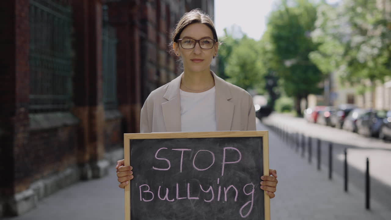 Woman Holding Sign Saying 'Stop Bullying'