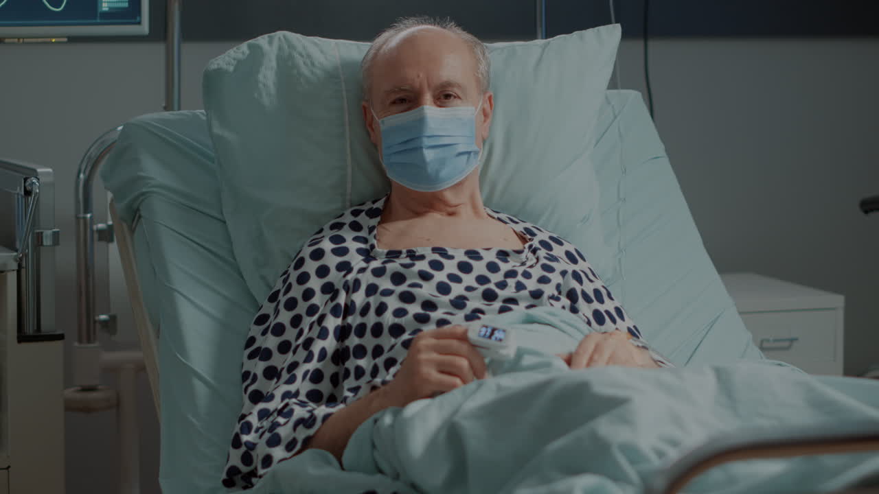 Old patient with face mask and oximeter