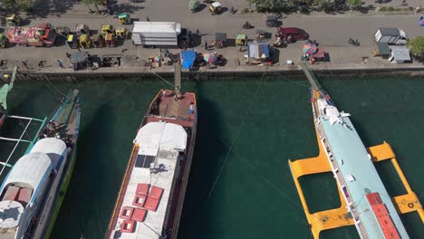 Cargo-ships-and-passenger-boats-anchored-in-bustling-harbor,-Surigao