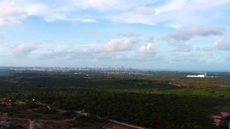 Beautiful-aerial-lowering-drone-shot-of-large-sky-scrapers-in-the-tropical-city-of-Joao-Pessoa,-in-Northern-Brazil-on-a-warm-sunny-summer-day