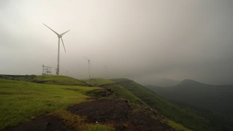 clouds and fog passing through wind turbines on summit of mountain range in sahyadri, india