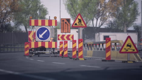 construction site with traffic signs and barriers on a city road
