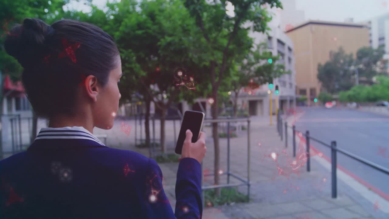 Woman pausing on sidewalk lifting phone checking tech tapping screen as glowing particles drifting