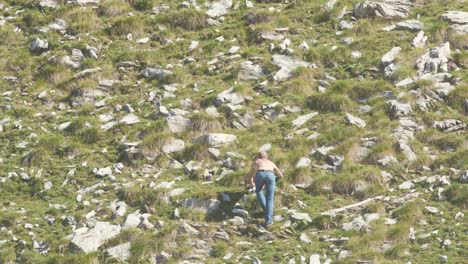 man hiking on rocky mountain slope