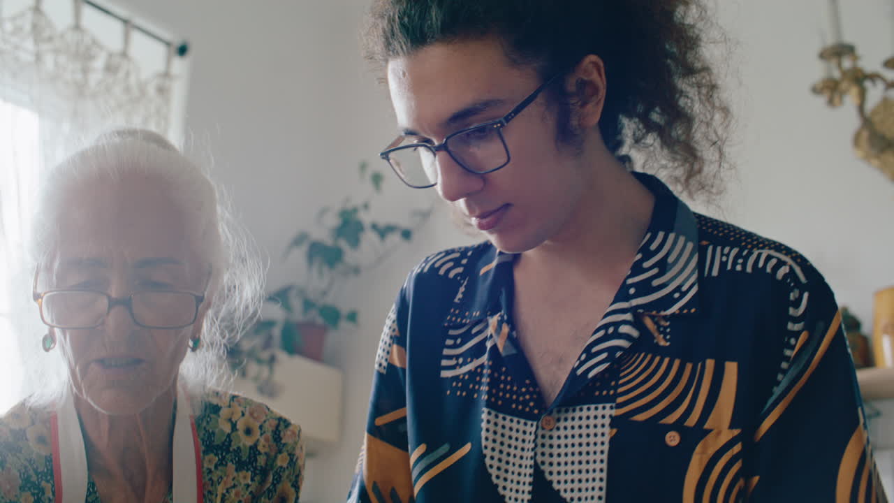 Boy Rolling Dough under Guidance of Grandmother in Home Kitchen