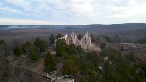 medieval castle ruins in american midwest landscape, aerial approach