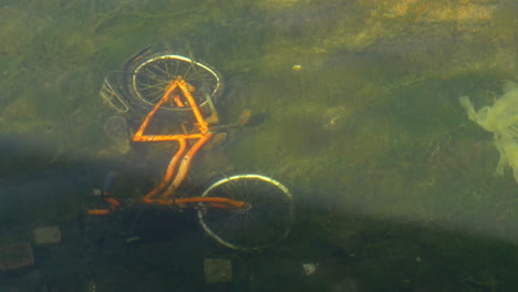 bicycle on the bottom of dirty pond