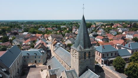 aerial view of a french village with a church tower