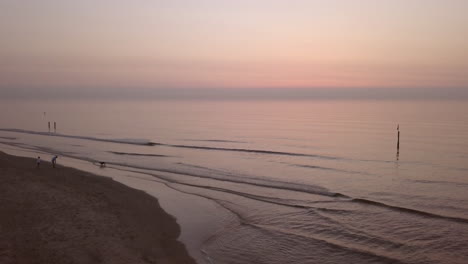 aerial shot of a calm northsea beach during sunset