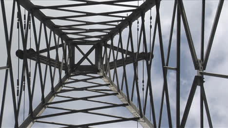 a utility tower climbs into the sky