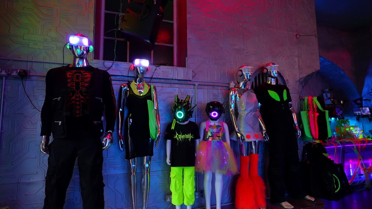 Futuristic mannequins in neon attire and LED helmets at Cyberdog store, Camden Town, London