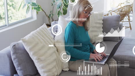 animation of financial data processing over senior caucasian woman using laptop