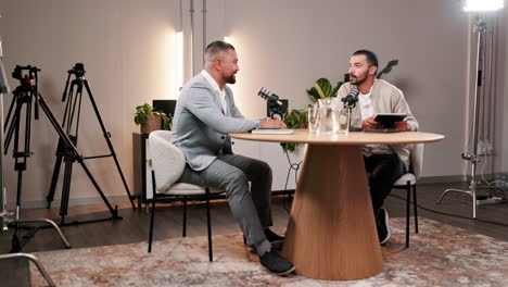 two men recording a podcast in a studio