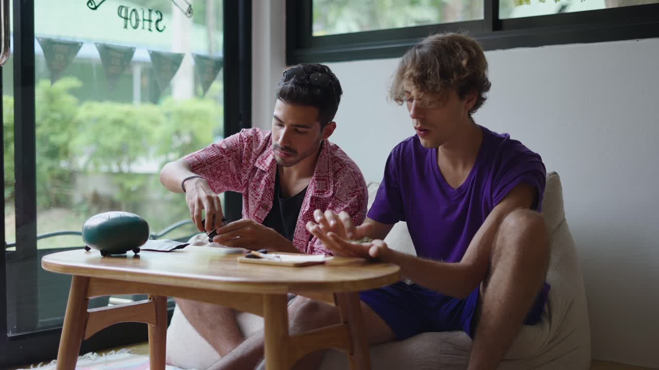Two men having a casual conversation in a cafe