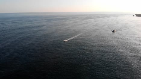 aerial view of two sailing luxury yacht during sunset in albufeira, portugal