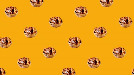 animación diagonal de bucle sin costuras con pasteles frescos y croissants franceses cubiertos de azúcar en polvo en una canasta rústica. comida moviéndose en un fondo amarillo con espacio de copia
