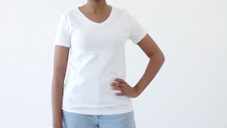 midsection of african american woman wearing white t-shirt with copy space on white background