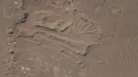 aerial view: garbage in peru desert is buried amid the sand dunes