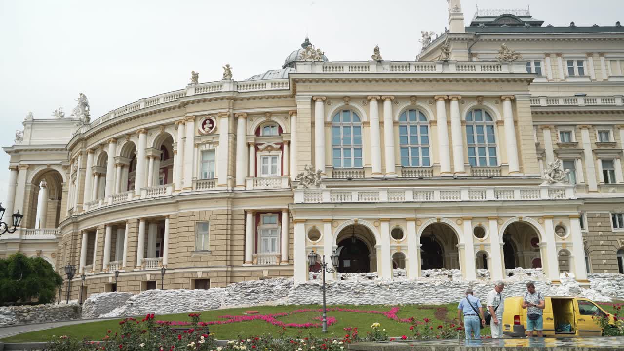 Odessa National Academic Opera and Ballet Theater during wartime from the side with people.